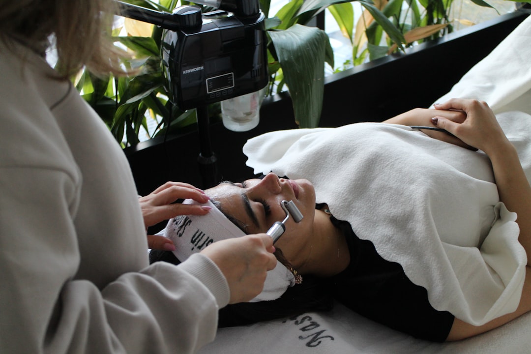 a-woman-laying-on-a-bed-while-using-a-cell-phone-bgqwj4v1c20